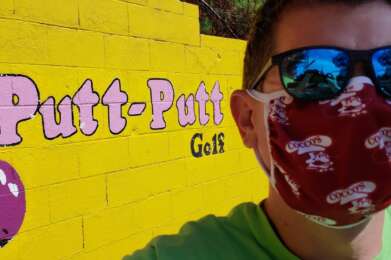 masked person with puttputt logo