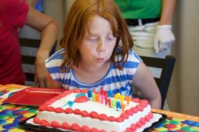 party kid blowing out candles