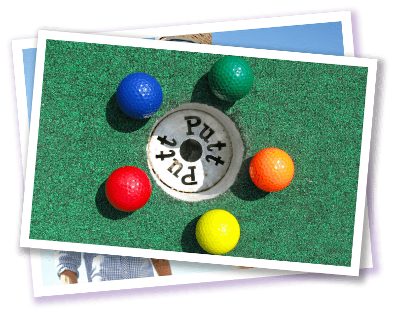 Putt-Putt Fun Center® multicolored Golf balls arranged around putt-putt golf hole. 